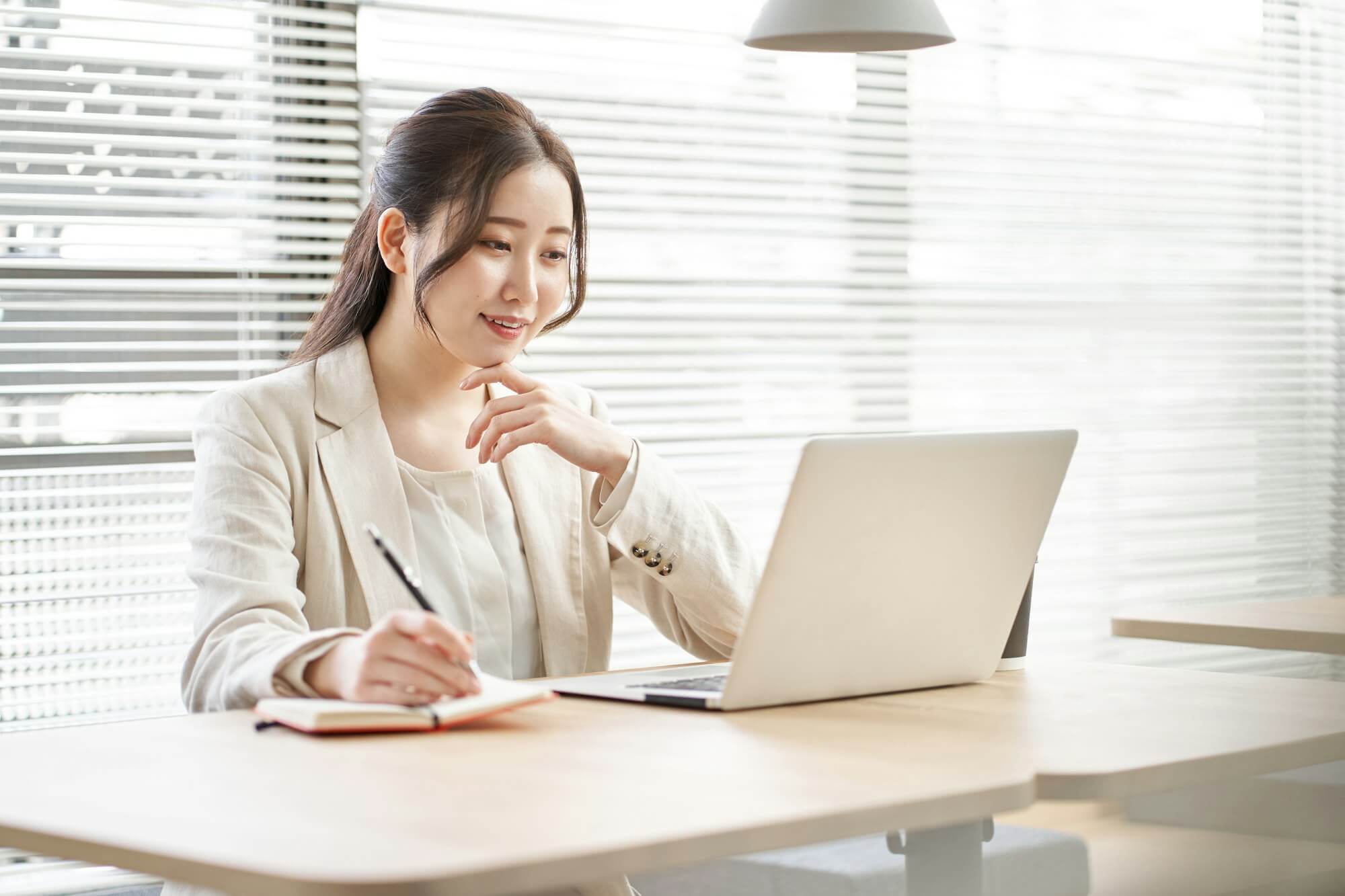 asian-woman-taking-notes-in-a-coworking-space.jpg